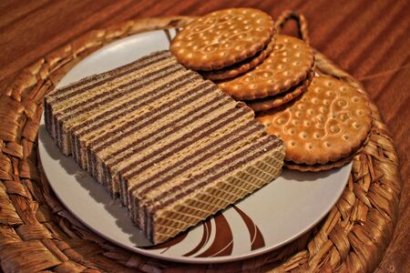 Cookies and wafers on a plateの写真素材