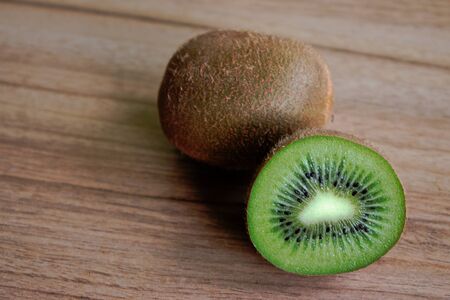 Closeup of kiwi on a wooden tableの写真素材