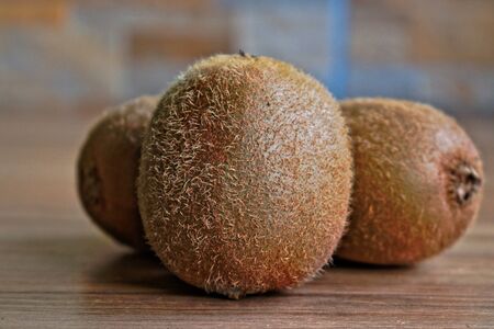 Closeup of kiwi on a wooden tableの写真素材