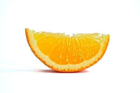 Closeup of an orange wedge on a white backgroundの写真素材