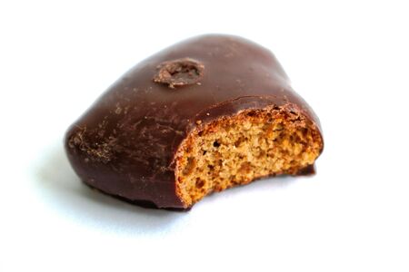 Chocolate heart with a bite mark on a white backgroundの写真素材