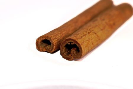 Closeup of cinnamon sticks on a white backgroundの写真素材