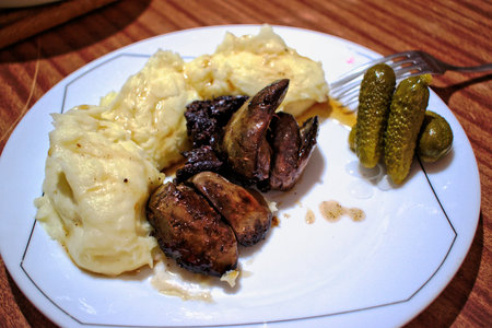 Liver and mashed potatoes with pickles on a plateの写真素材