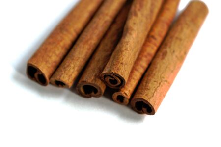 Closeup of cinnamon sticks on a white backgroundの写真素材