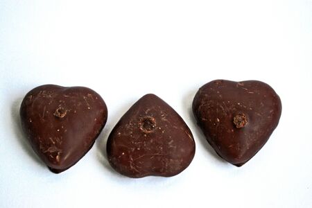 Chocolate covered gingerbread hearts on a white backgroundの写真素材