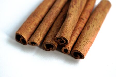 Closeup of cinnamon sticks on a white backgroundの写真素材