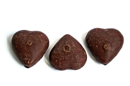Chocolate covered gingerbread hearts on a white backgroundの写真素材