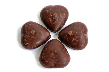 Chocolate covered gingerbread hearts on a white backgroundの写真素材
