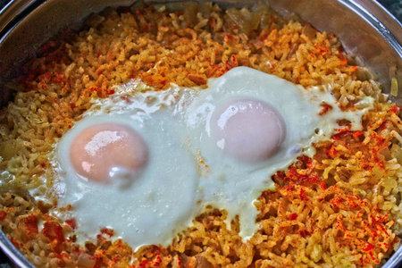Closeup of two fried eggs on riceの写真素材