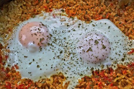 Closeup of two fried eggs on riceの写真素材