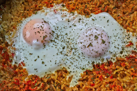 Closeup of two fried eggs on riceの写真素材