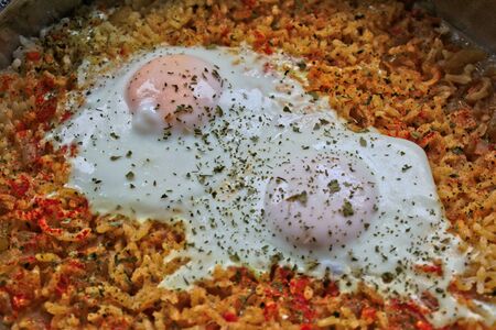 Closeup of two fried eggs on riceの写真素材