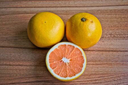 Closeup of grapefruits on a wooden tableの写真素材