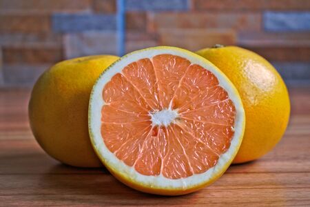 Closeup of grapefruits on a wooden tableの写真素材