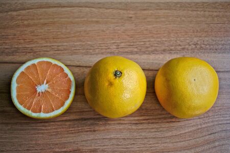 Closeup of grapefruits on a wooden tableの写真素材