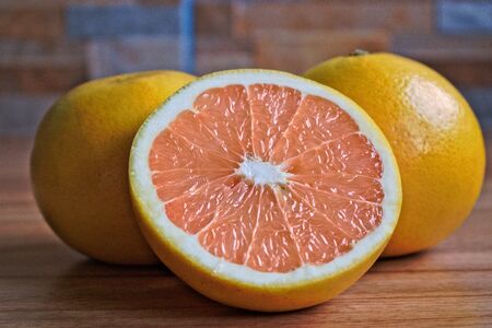 Closeup of grapefruits on a wooden tableの写真素材