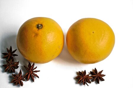 Two grapefruits and star anise on a white backgroundの写真素材