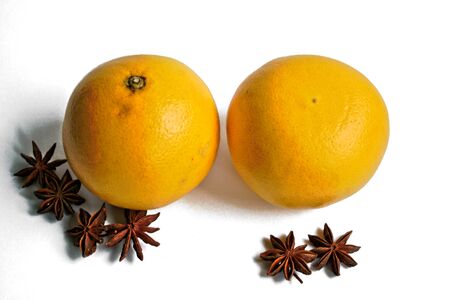Two grapefruits and star anise on a white backgroundの写真素材