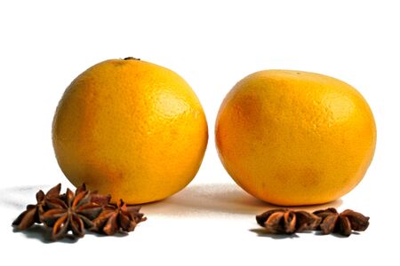 Two grapefruits and star anise on a white backgroundの写真素材
