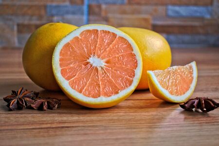 Closeup of grapefruits and star anise on a wooden tableの写真素材