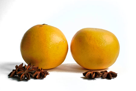 Two grapefruits and star anise on a white backgroundの写真素材