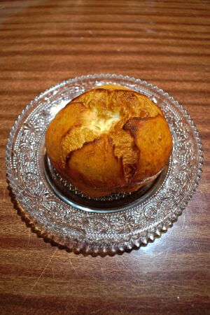 Closeup of a doughnut on a wooden tableの写真素材
