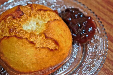 Homemade doughnut with jam on a wooden tableの写真素材