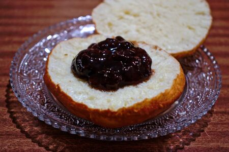 Homemade doughnut with jam on a wooden tableの写真素材