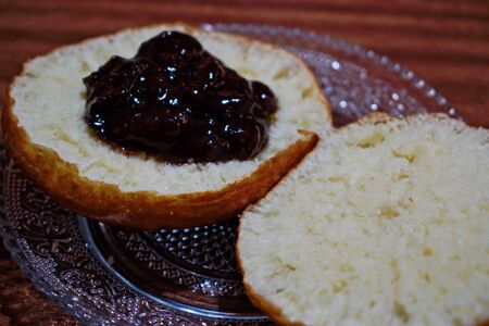 Homemade doughnut with jam on a wooden tableの写真素材