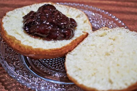 Homemade doughnut with jam on a wooden tableの写真素材