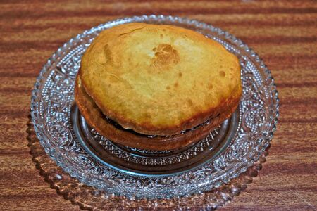 Homemade doughnut with jam on a wooden tableの写真素材