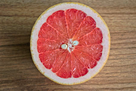 Closeup of a grapefruit half on a wooden tableの写真素材
