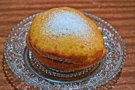 Homemade doughnut with jam on a wooden tableの写真素材