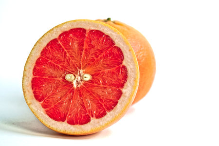 Closeup of red grapefruits on a white backgroundの写真素材
