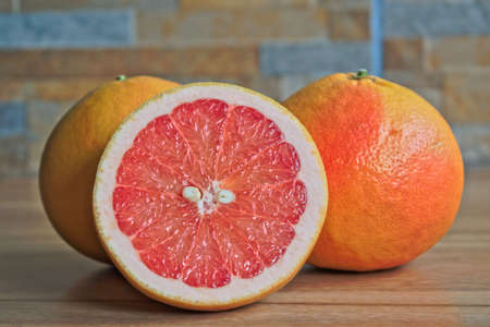 Closeup of red grapefruits on a wooden tableの写真素材