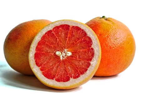 Closeup of red grapefruits on a white backgroundの写真素材