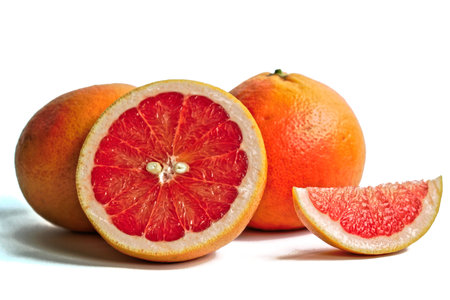 Closeup of red grapefruits on a white backgroundの写真素材