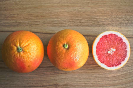 Closeup of red grapefruits on a wooden tableの写真素材