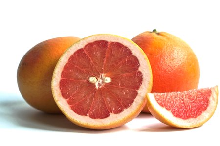 Closeup of red grapefruits on a white backgroundの写真素材