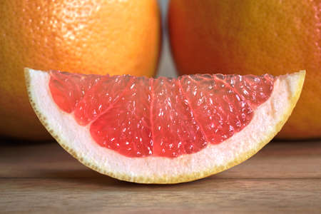 Closeup of red grapefruits on a wooden tableの写真素材