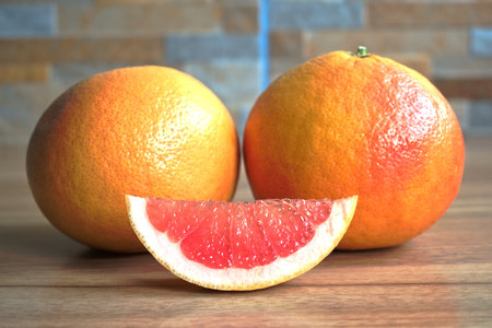 Closeup of red grapefruits on a wooden tableの写真素材