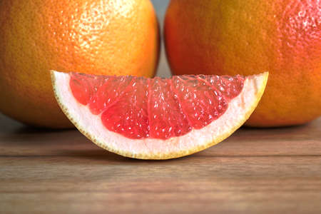 Closeup of red grapefruits on a wooden tableの写真素材