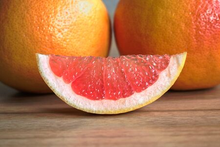 Closeup of red grapefruits on a wooden tableの写真素材