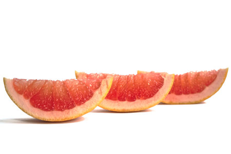 Closeup of a grapefruit wedges on a white backgroundの写真素材