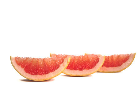 Closeup of a grapefruit wedges on a white backgroundの写真素材