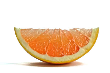 Closeup of a grapefruit wedge on a white backgroundの写真素材