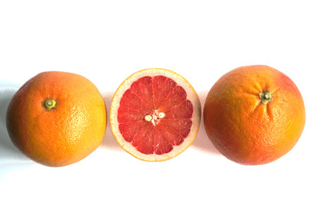 Closeup of red grapefruits on a white backgroundの写真素材