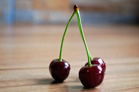 Closeup of cherries on a wooden tableの写真素材