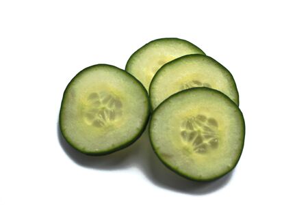 Closeup of cucumber slices on a white backgroundの写真素材