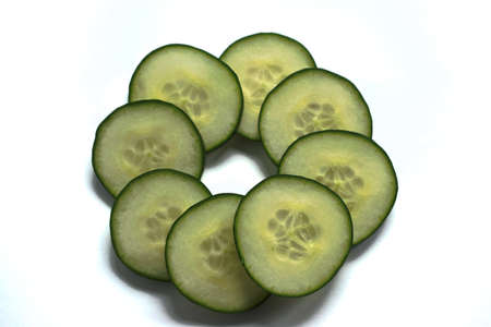 Closeup of cucumber slices on a white backgroundの写真素材